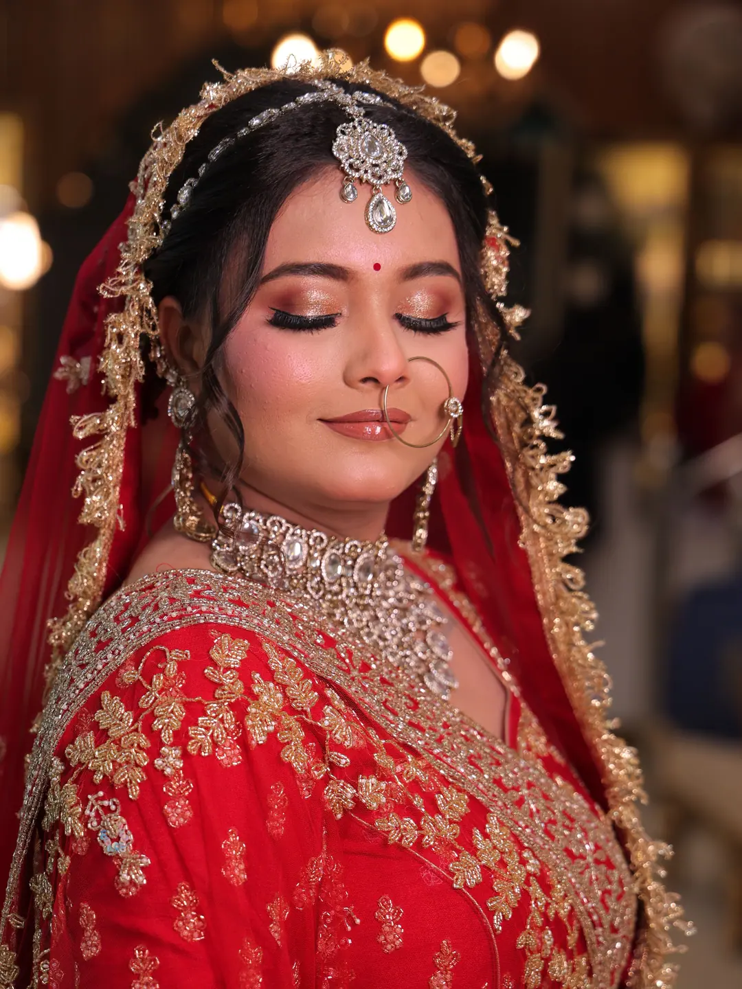 Bride in red and pink bridal look by Ruby Makeover
