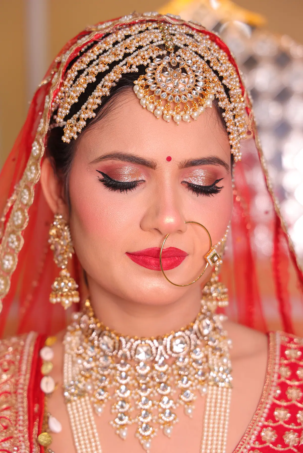Bride in traditional bridal makeup and jewellery by Ruby Makeover